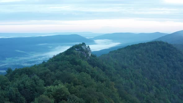 An aerial shot (clockwise orbit) of Big Schloss and the Trout Run Valley at dawn in the summer, loca