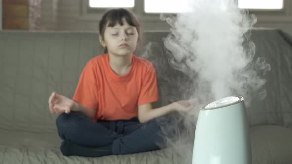 Girl Meditation By Air Humidifier