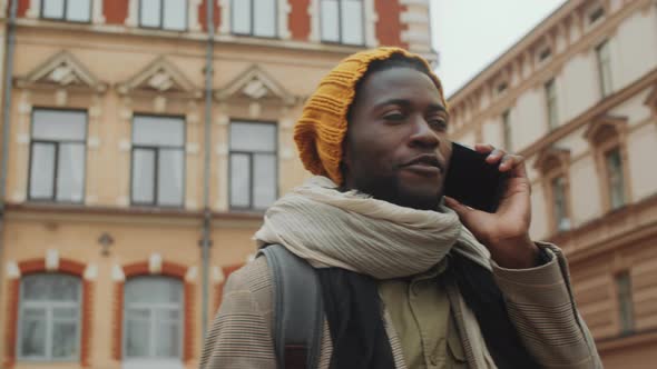 Black Male Tourist Chatting on Phone in Old Town