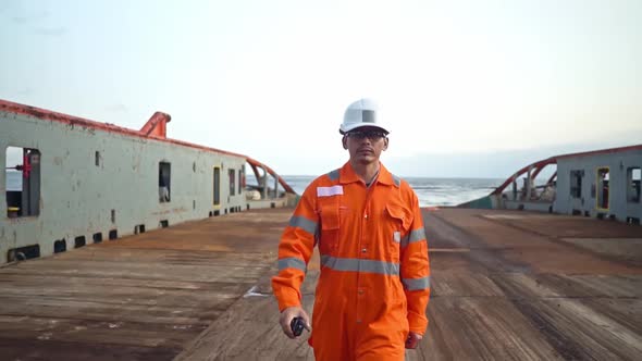 Filipino Deck Officer on Deck of Vessel or Ship , Wearing PPE Personal Protective Equipment