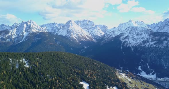 Aerial drone view of snow covered mountains in the winter