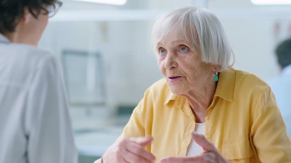 Elderly Female Patient Talking to Doctor