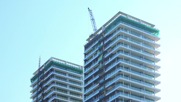 Tops of Two High-rise Buildings Under Construction - the Clear Blue Sky in the Background