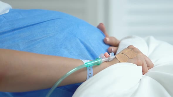 Pregnant Woman Suffering Painful Contractions Lying Hospital Bed, Clinic Labor