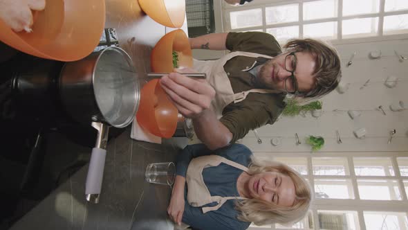 Man And Woman Cooking Poached Egg