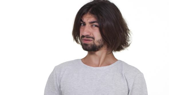 Surprised Caucasian Guy Incredulously Looking at Camera Isolated Over White Background in Slowmotion