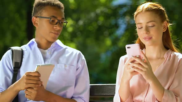 Black Teen Trying to Get Acquainted With Nice Girl Scrolling Phone Ignoring Guy