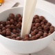 Pouring Milk into Bowl of Chocolate Ball-Shaped Cereals - VideoHive Item for Sale