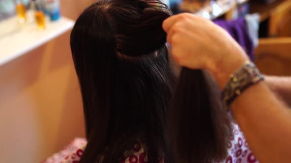 Hairdresser Combing Long Hair of a Girl Before Cutting