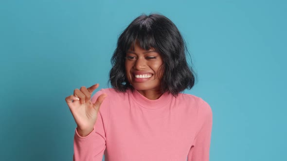 Young Asian Woman with Dark Skin Shows Very Tiny Object Shapes Small Item