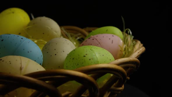 Rotating shot of Easter decorations and candy in colorful Easter grass