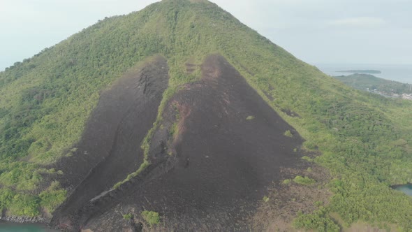 Aerial: flying over Banda Islands active volcano Gunung Api lava flow Indonesia