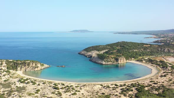 Aerial drone video of semicircular sandy beach and lagoon of Voidokilia