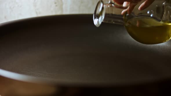 Man Pouring Cooking Oil on the Frying Pan  Top View