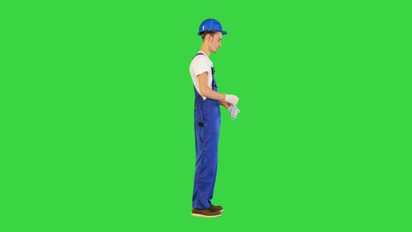 Construction Worker Wearing Protective Gloves on a Green Screen Chroma Key