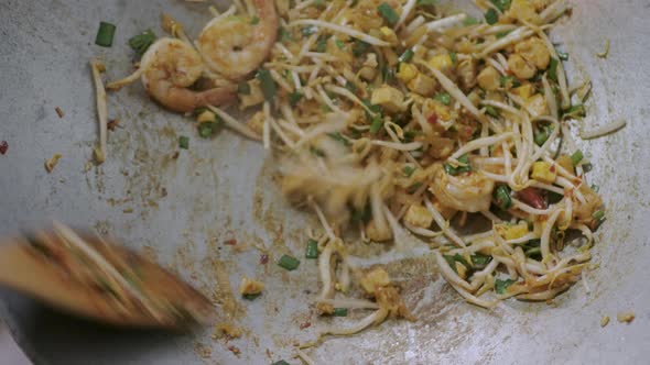 cooking fry Pad Thai in kitchen. Famous street food of thailand