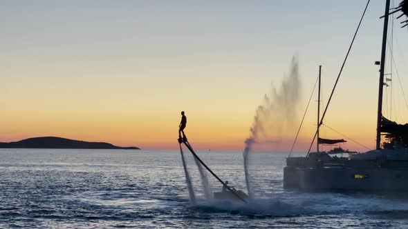 Flyboarding - Silhouette Of Rider Enjoying Flyboard In The Ocean During Golden Hour In Hvar Island,