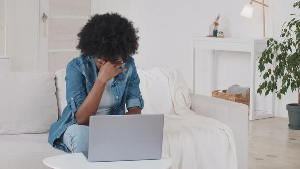 Stressed Young African American Woman Feeling Headache Migraine or Eye Strain Working on Laptop at