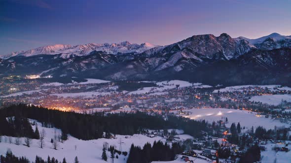 Illuminated Zakopane city after dusk in winter, aerial view