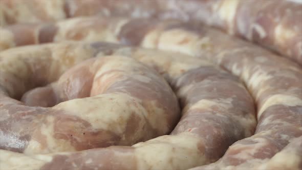 Raw Homemade Sausage Lies on the Cutting Board