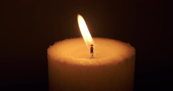 Burning candle extinguished to darkness