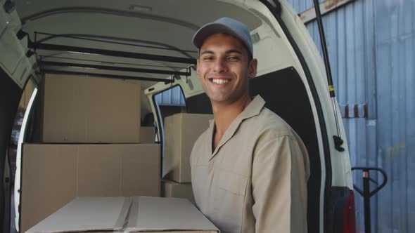 Portrait of male van driver with a warehouse delivery