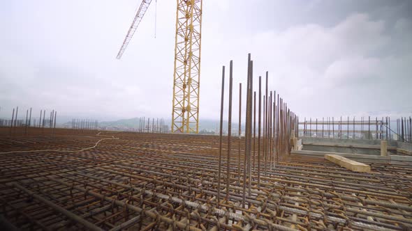 Iron reinforcement is basis for pouring foundation of house with concrete slab.