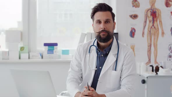 Handheld video shows of male doctor in doctor’s office. Shot with RED helium camera