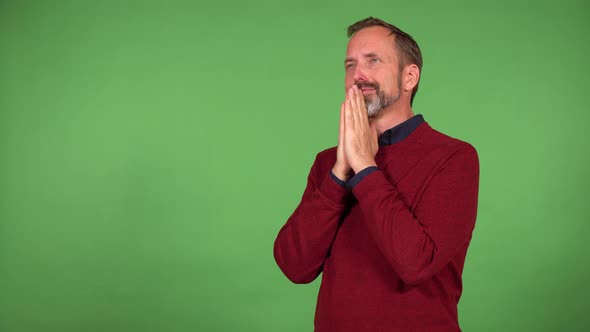 A Middleaged Handsome Caucasian Man Prays  Green Screen Background