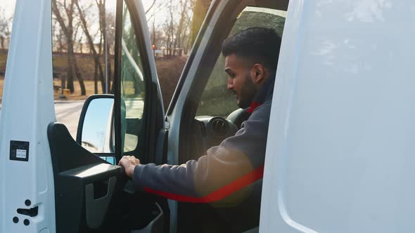 Young Indian Driver Getting Out of the Van and Stretching