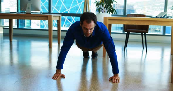 Male executive doing pushups