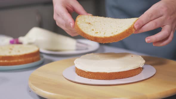 The Pastry Chef Puts the Second Layer of Sponge Cake