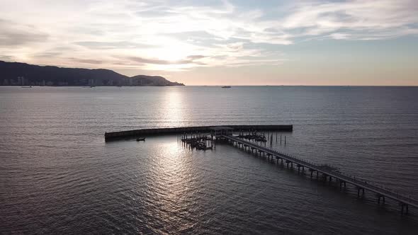 Aerial view sunset boat coming back to jetty Nelayan Bagan Ajam