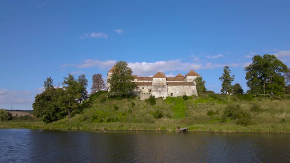 Aerial Drone Shot of Historic Castle on Hill Near Lake Medieval Architecture and Cultural Landmark