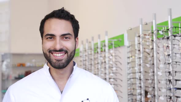 Optician Doctor Near Showcase With Eyeglasses At Glasses Shop