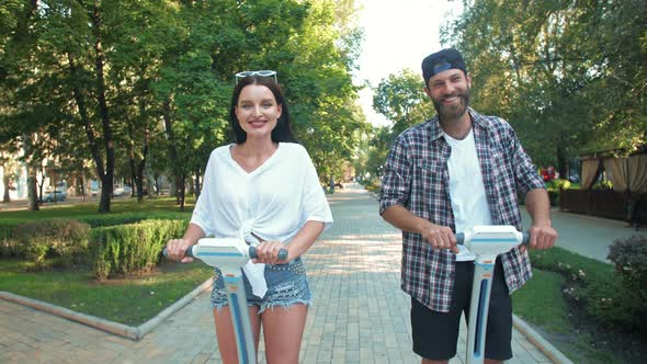 Couple on a Date Riding Electric Scooter