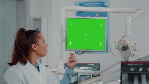 Close Up of Dentist Looking at Monitor with Green Screen