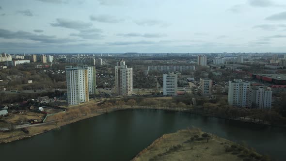 City block near the river. Multi-story houses. Water city system. Aerial photography.