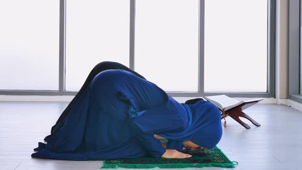 Muslim young women in traditional hijab are praying glorify Allah