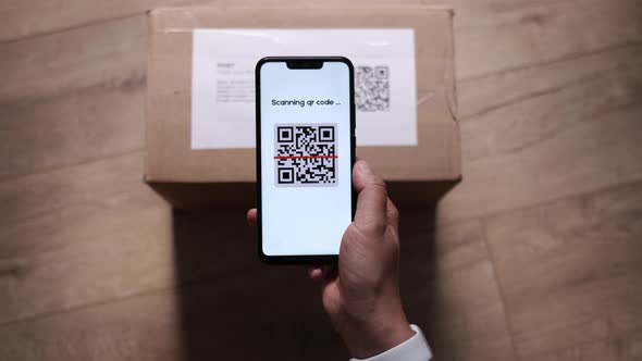 CloseUp POV of Female Holding QR Code Scanner on Smartphone App Scanning Parcel Bar Code