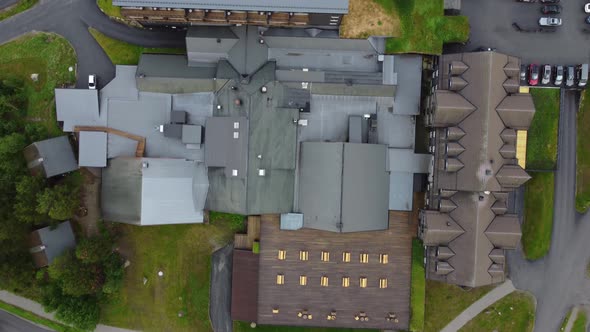 Rooftop and surroundings at Vestlia resort and hotel - Forward moving top-down aerial showing roof b