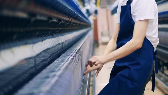 Factory Employee is Fixing Extra Threads in Textile Machinery