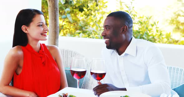 Romantic couple toasting their wine glasses