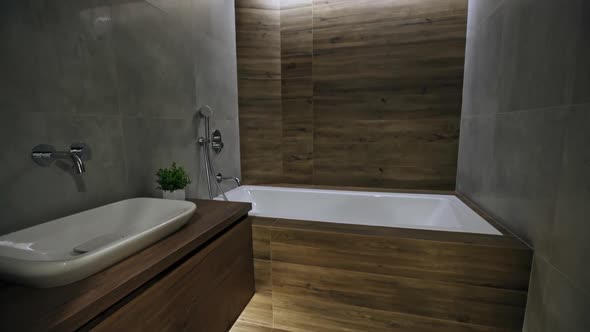 Interior of a Fitted Modern Bathroom Interior with Wood or Timber Decor and a White Hand Basin