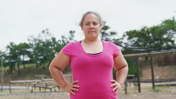 Caucasian woman looking at camera at boot camp