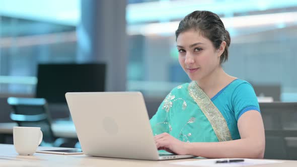 Thumbs Up by Young Indian Woman with Laptop