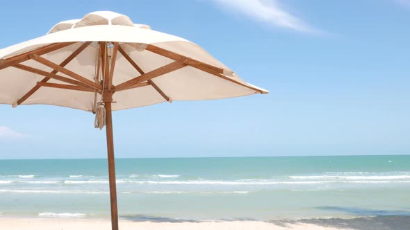 Beautiful tropical sea beach around with umbrella chair on blue sky