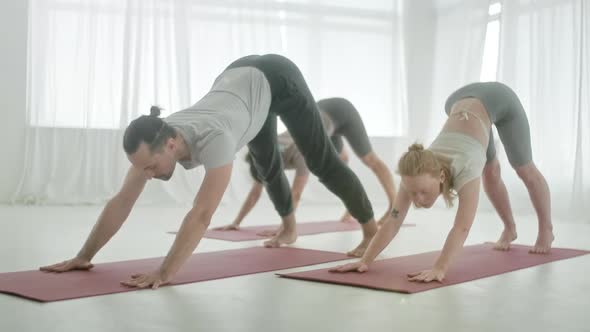 Five Young Women and Man in Yoga Class Meditation Exercises