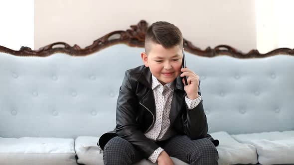 Little Schoolboy Talking on a Smartphone