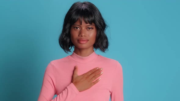 Serious Dark Skinned Asian Young Woman Makes Promise Gesture